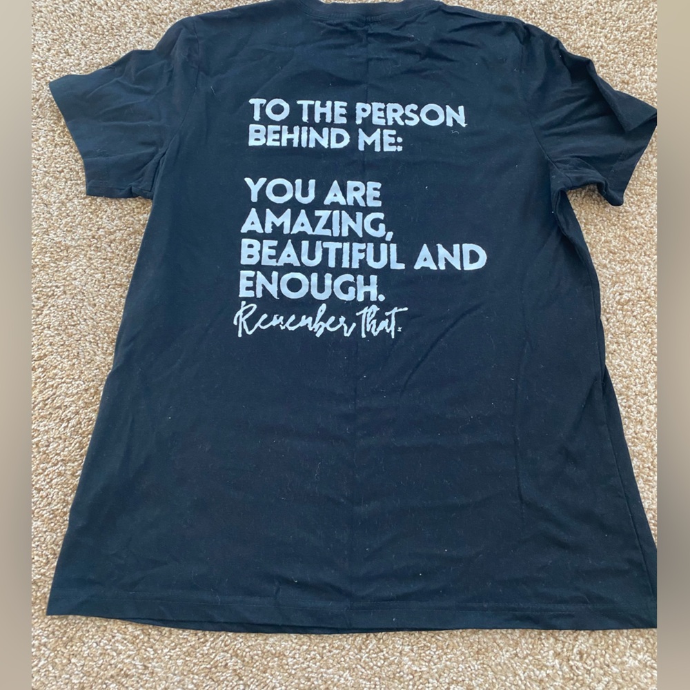 Black tee with motivational sayings on back. Size medium